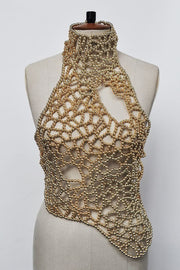 A gold beaded crochet halter top displayed on a beige fabric mannequin torso against a plain white background.