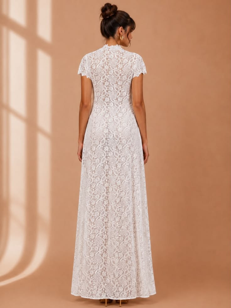Embroidered White Lace Top in white floral lace with short sleeves, a fitted waist and a floor-length sheer hem
