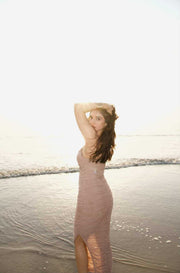 Moni Dress in dusty beige with a fitted sleeveless silhouette, ruched fabric, and a high side slit