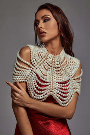 Pearl Cape Top with layered ivory pearl strands draped over the shoulders and neckline, worn over a red dress