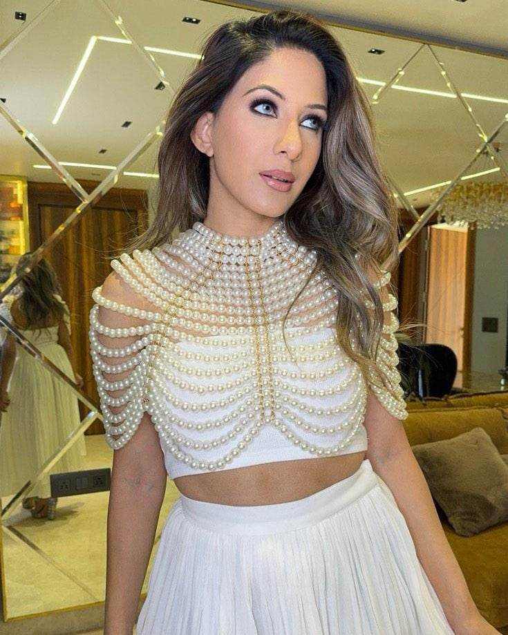 Pearl Cape Top in white, with layered pearl strands forming a high-neck, draped cape over a sleeveless crop top