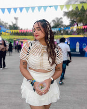 Pearl Cape Top in white, featuring layered pearl strands, short sleeves, and a cropped draped silhouette