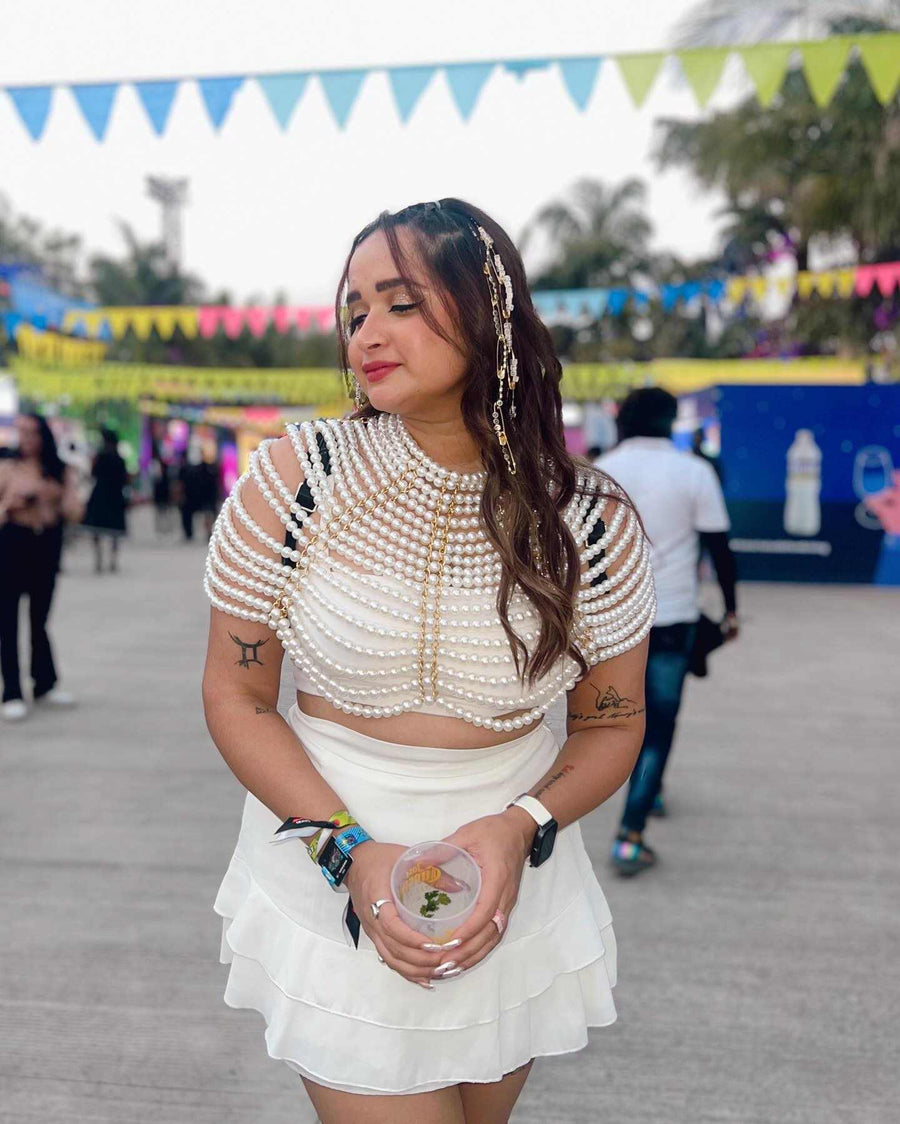 Pearl Cape Top in white, featuring layered pearl strands, short sleeves, and a cropped draped silhouette
