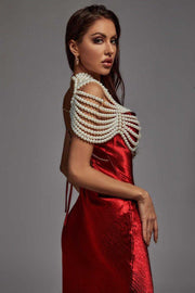 Pearl Cape Top featuring layered white pearl strands draped over the shoulders above a red satin dress