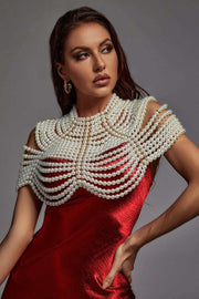 Pearl Cape Top with layered white pearl strands draped over a red satin sleeveless dress